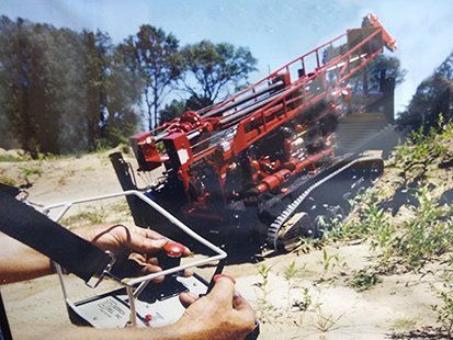 Operator using an industrial wireless control with a neck strap.