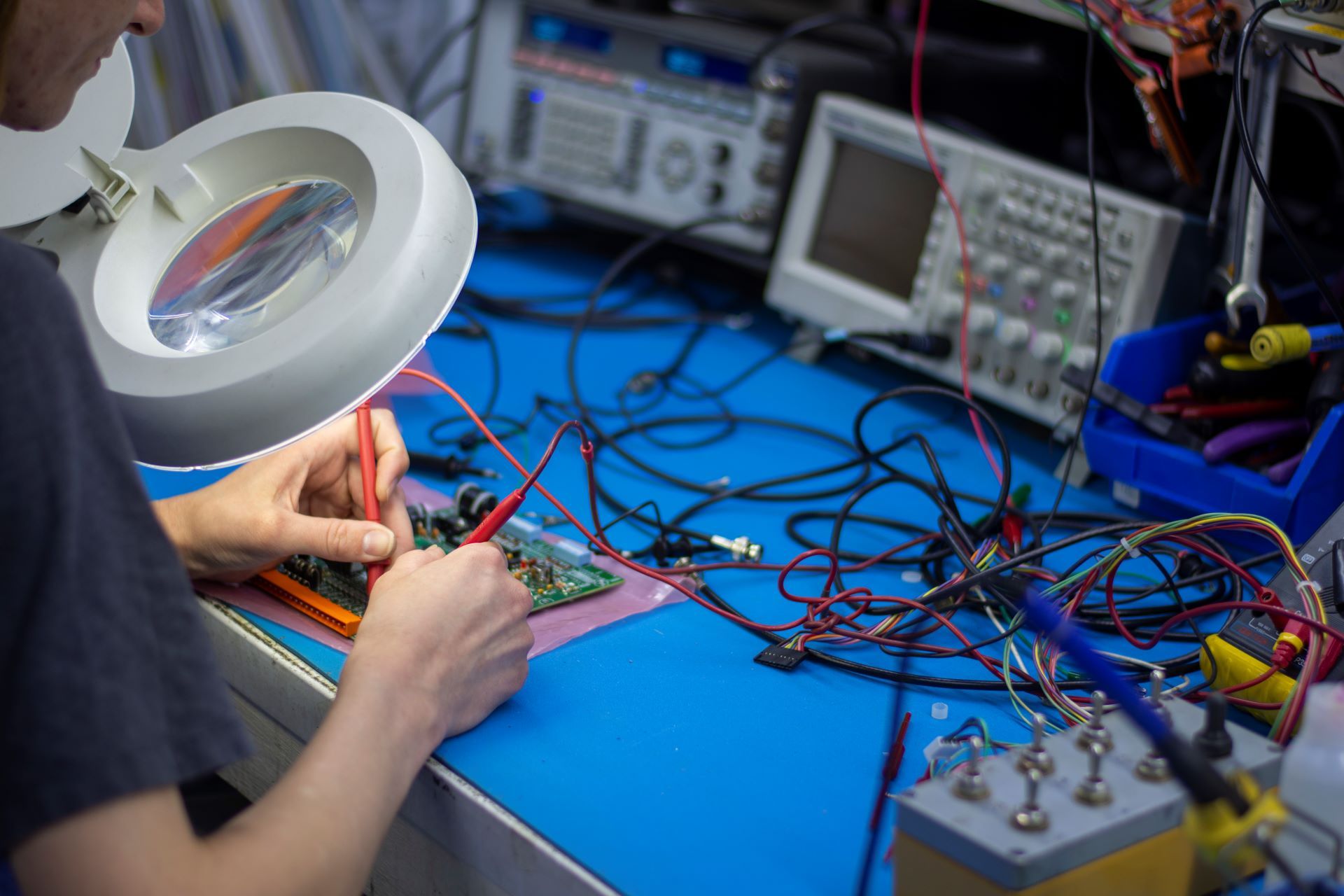 A Microtronics engineer designing equipment at a work table