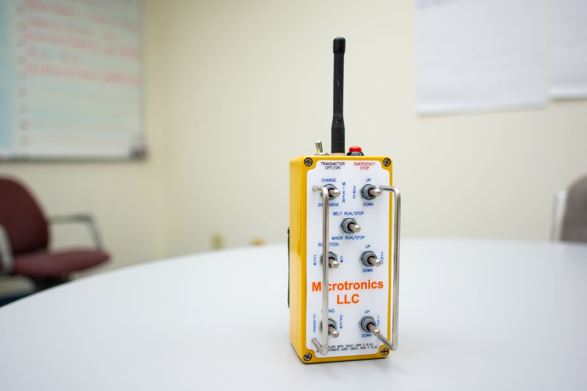 a Microtronics controller with 7 switches, and an emergency stop button