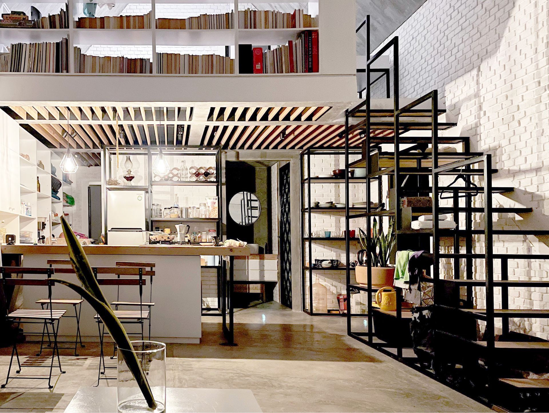Un salón con escalera que conduce al segundo piso.