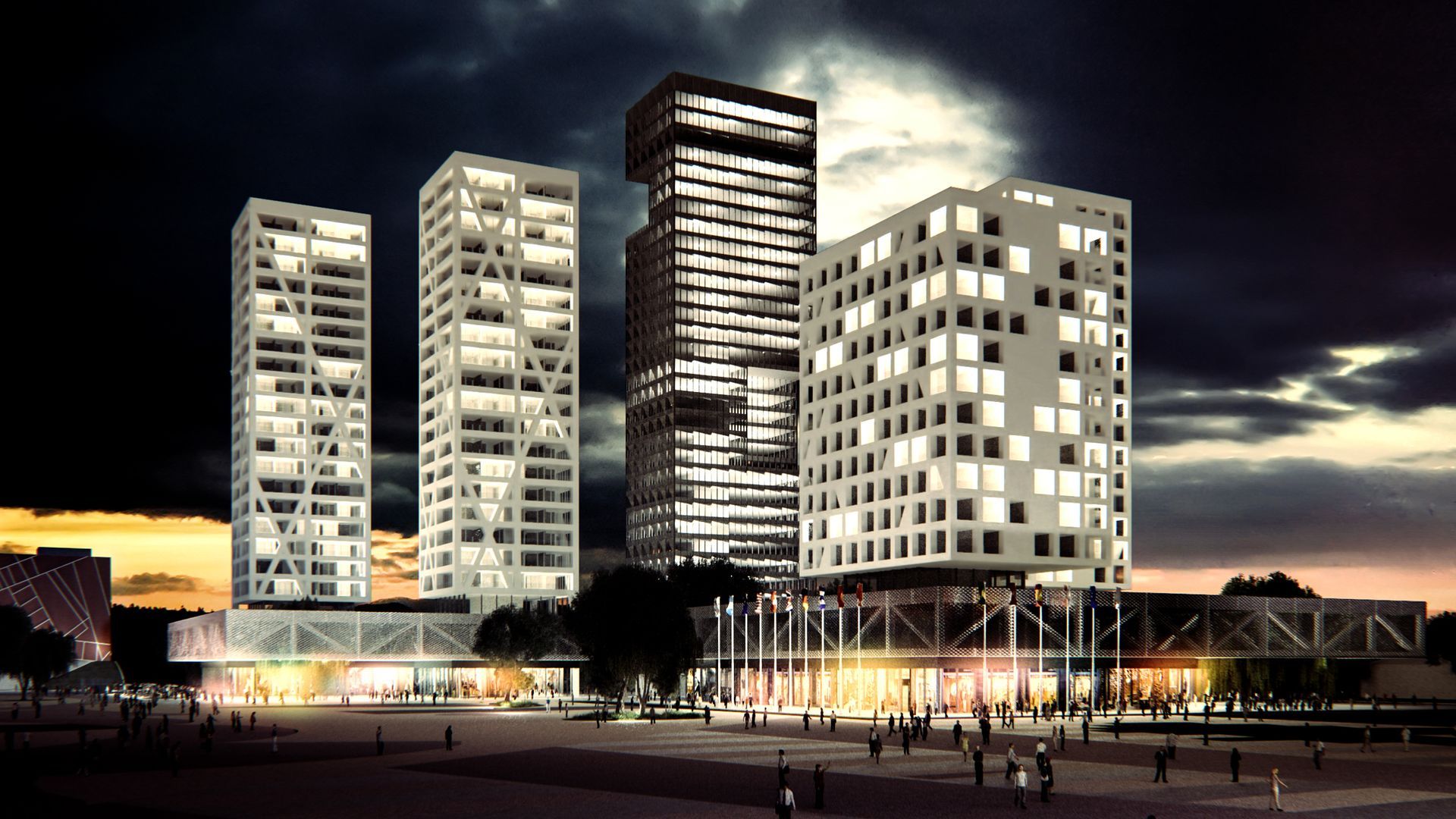 Un grupo de edificios altos se iluminan por la noche.