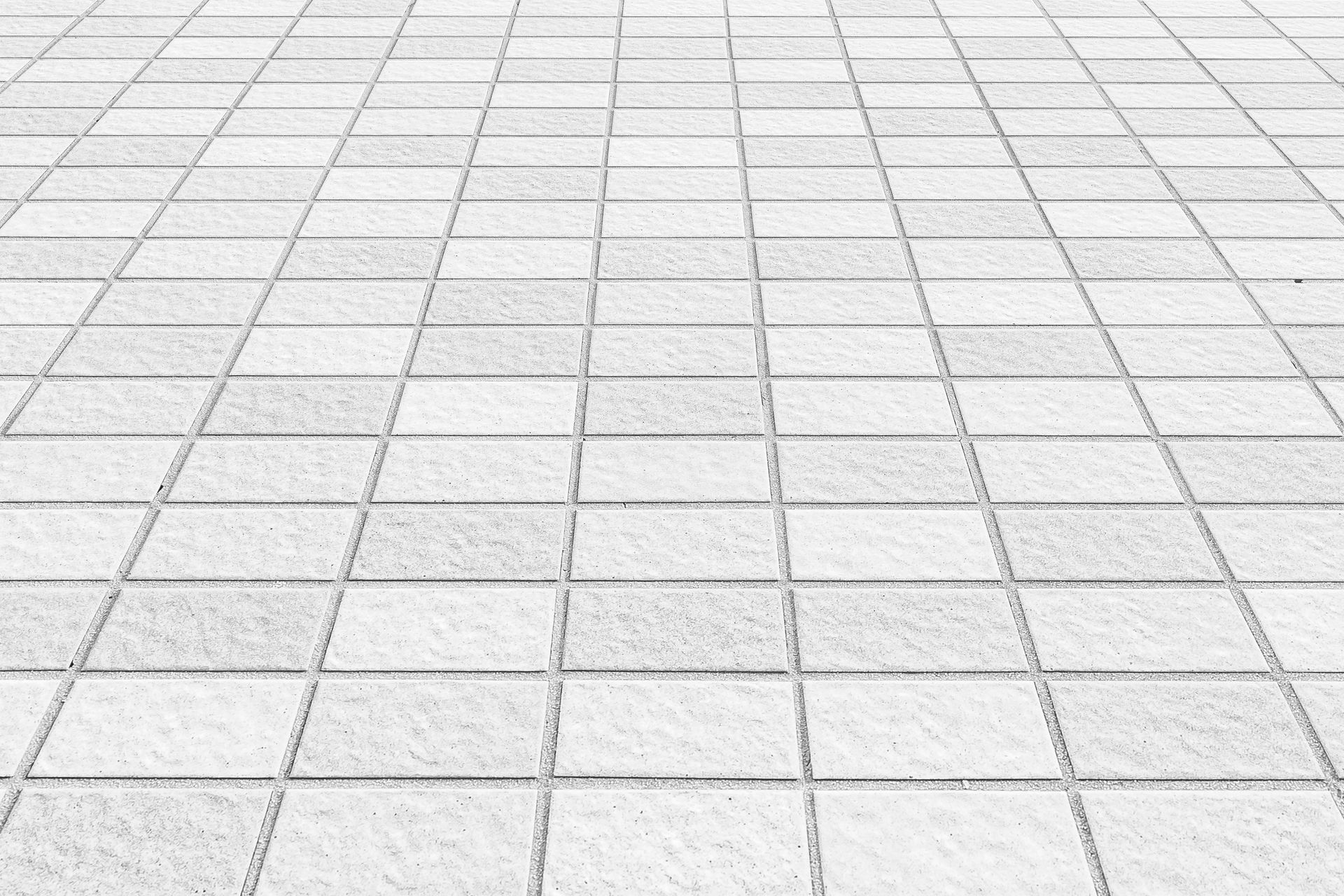 White rectangular subway tiles on two walls meeting at a corner with dark grout lines.