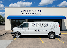 White On The Spot Floor Care van parked outside storefront with blue awning and company sign