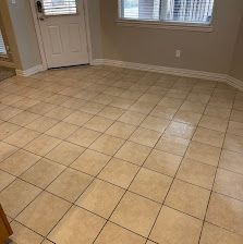 Empty tiled room with beige floor, white walls, a door, and windows with blinds