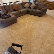 Brown sectional sofa in a living room with a beige carpet and wooden furniture