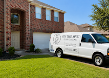 White service van parked outside a brick house on a sunny suburban street.