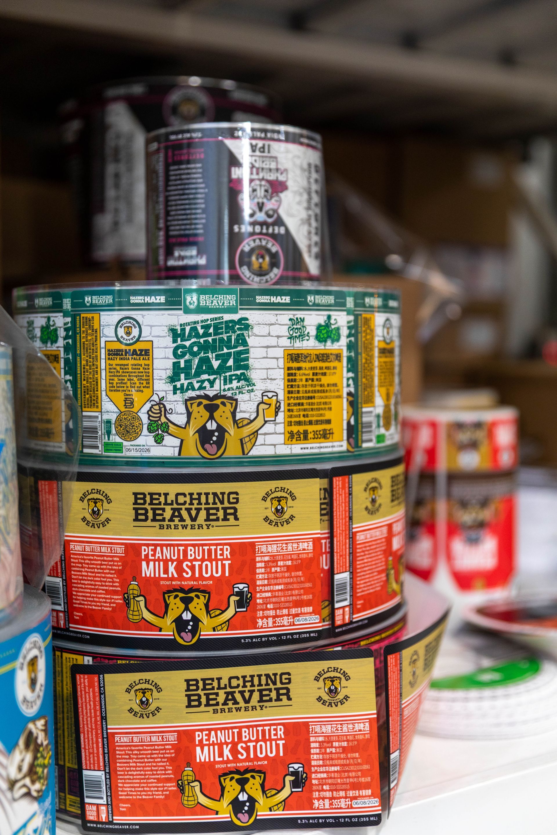 three cans of skyduster beer are sitting on top of a dirt field .