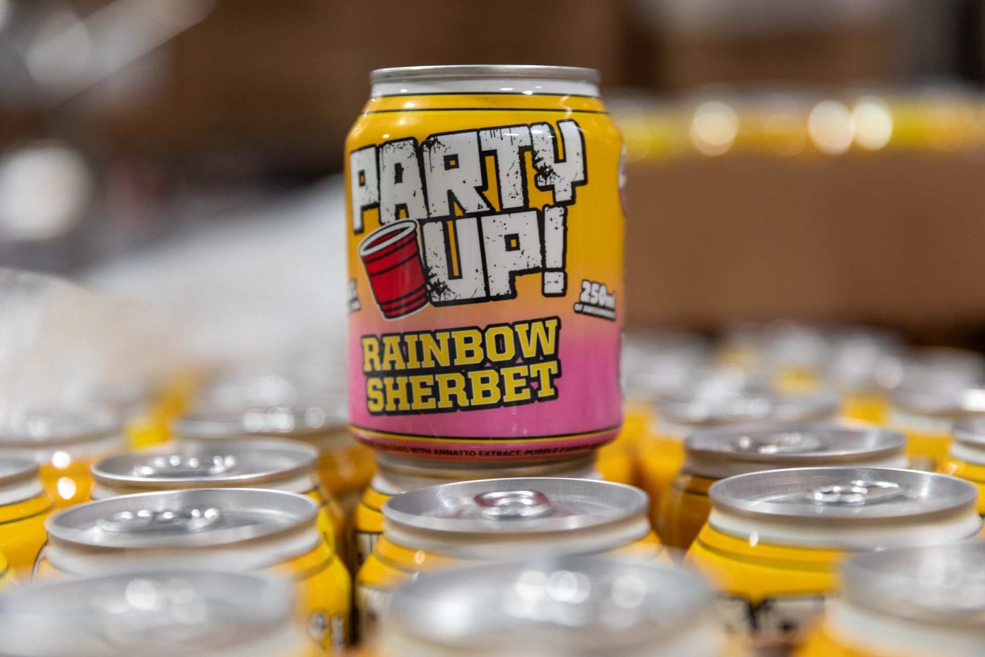 three cans of beer are sitting on a table .