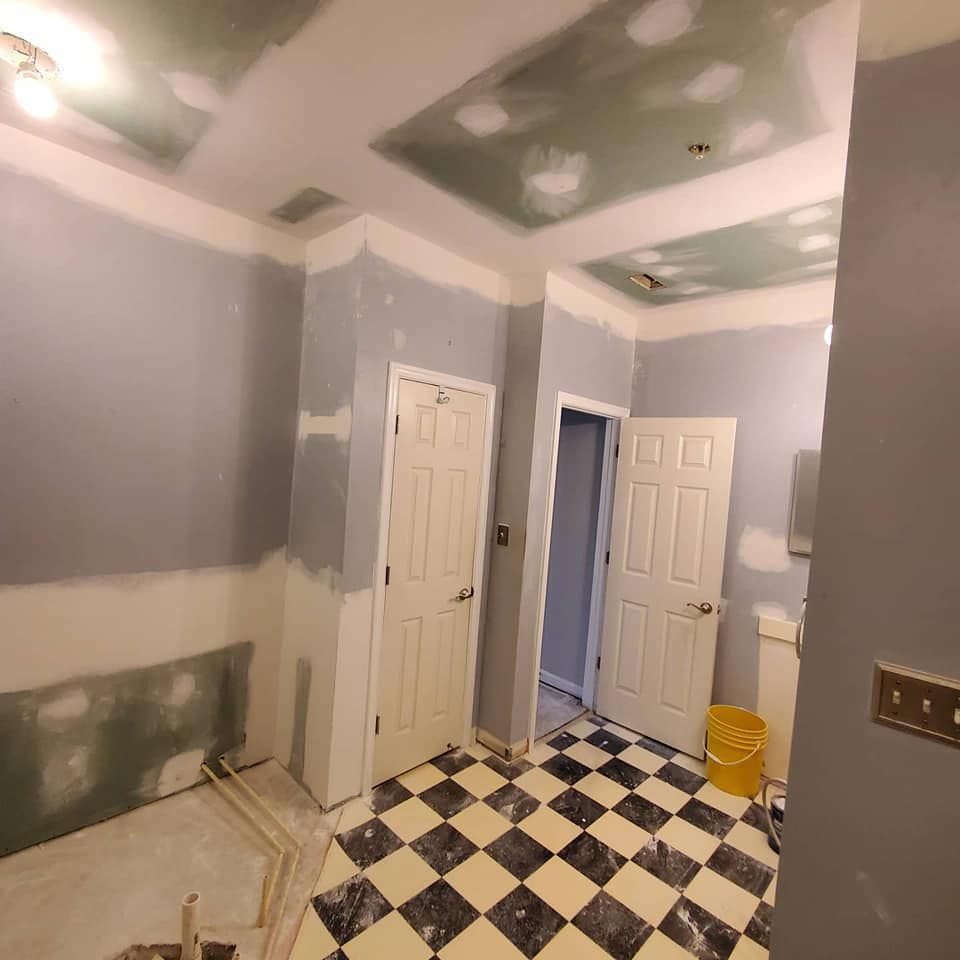 A bathroom under construction with a checkered floor.