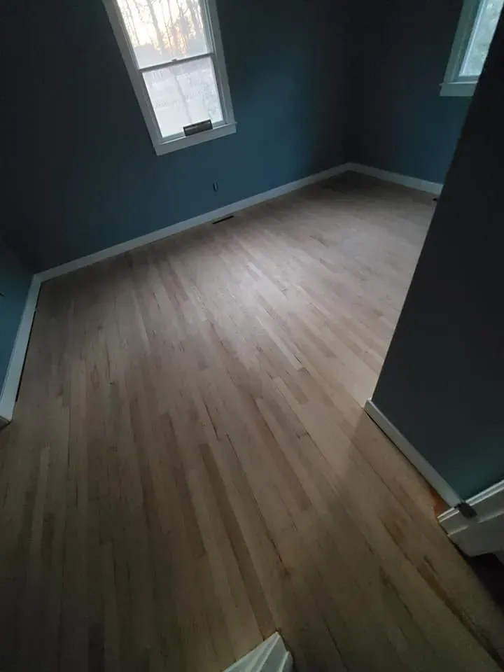 A room with hardwood floors and blue walls.