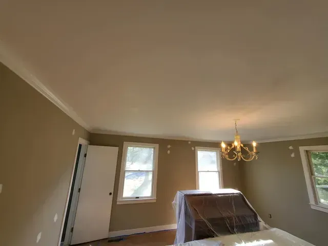 A room with a chandelier hanging from the ceiling.