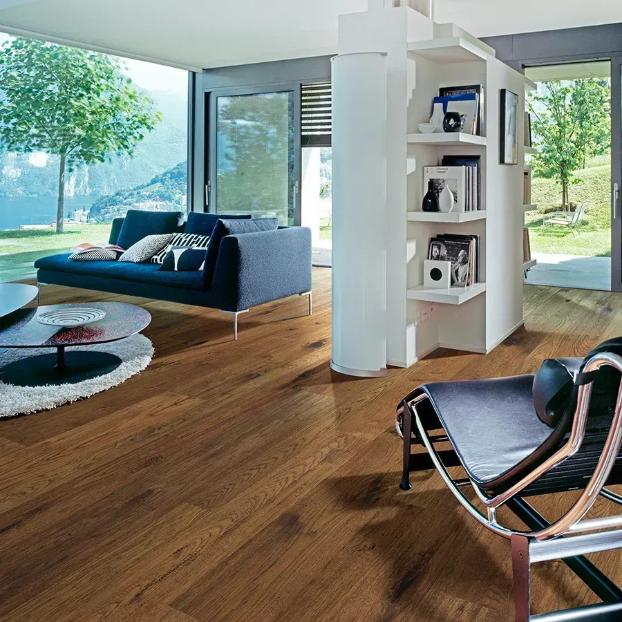 A living room with hardwood floors and a couch and chair