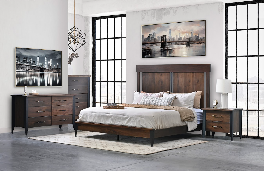 A bedroom with a bed , dresser , nightstand , and painting on the wall.