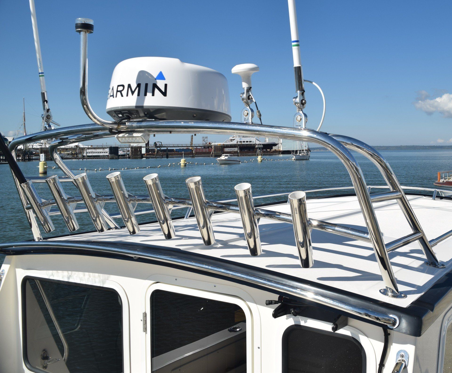 A boat with a Tanner Manufacturing radar arch and rod holder bar on it.