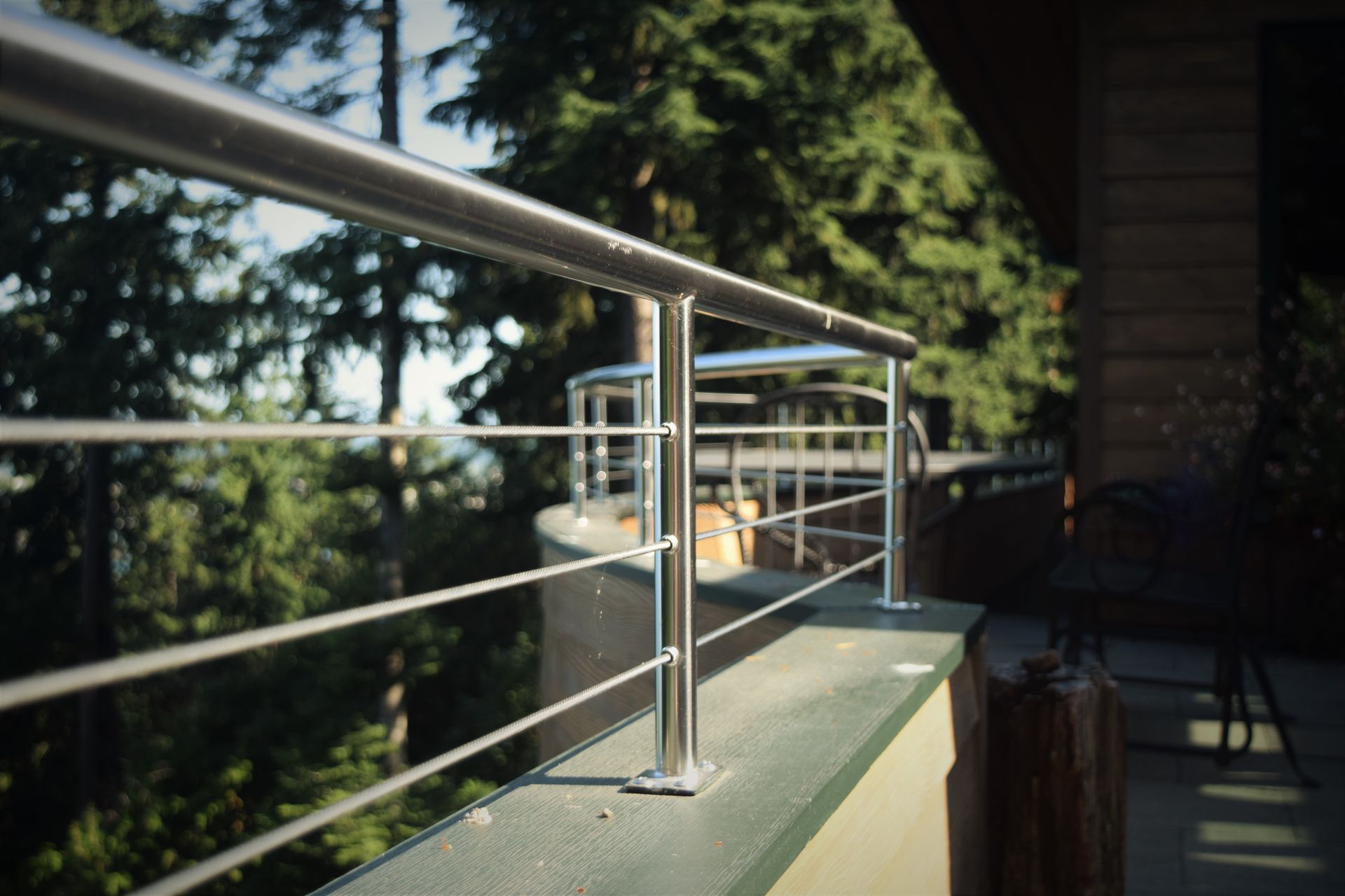 An architectural stainless steel deck railing with cables made by Tanner Manufacturing.