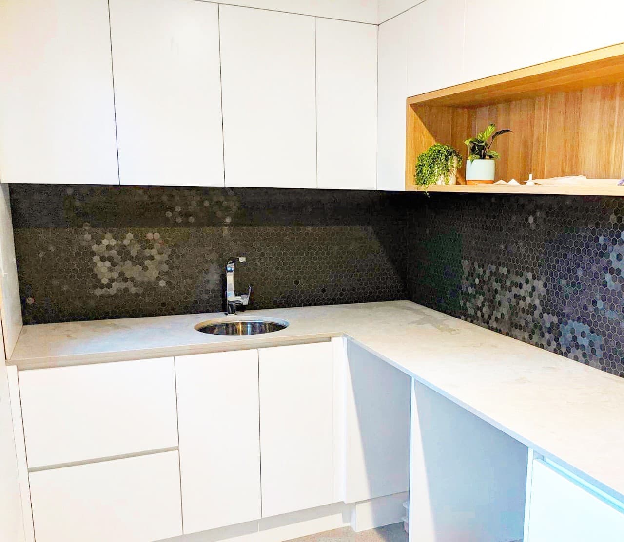 Laundry with Metallic Black Hexagon Tiles — Impact Bathrooms in Bateau Bay, NSW