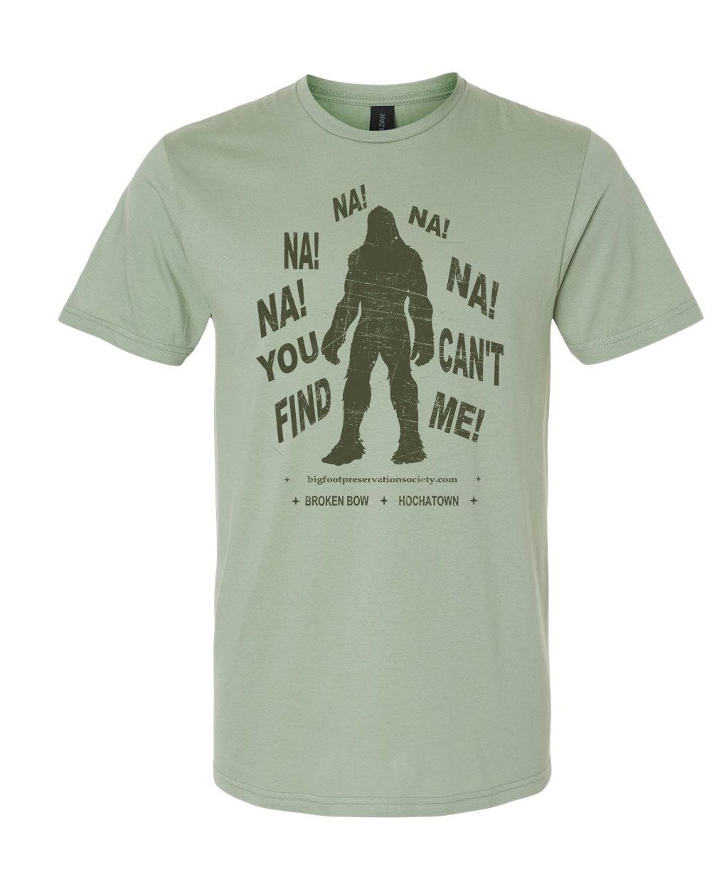 Light green T-shirt with a Bigfoot graphic and text saying “You can’t find me!”