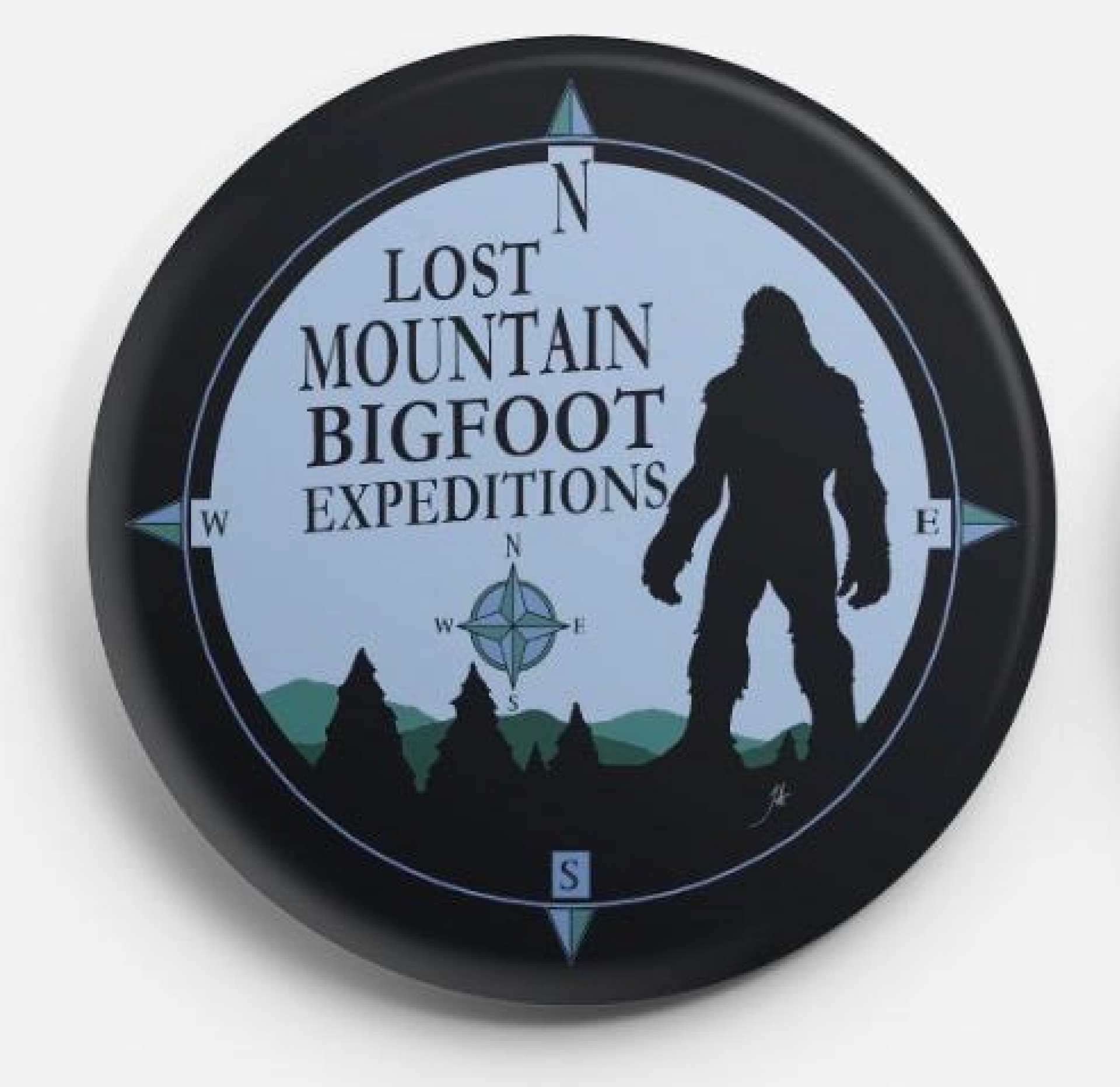 Lost Mountain Bigfoot Expeditions compass-style logo with silhouette of Bigfoot and mountains