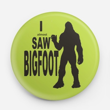 Lime green button with black Bigfoot silhouette and text “I almost saw BIGFOOT”