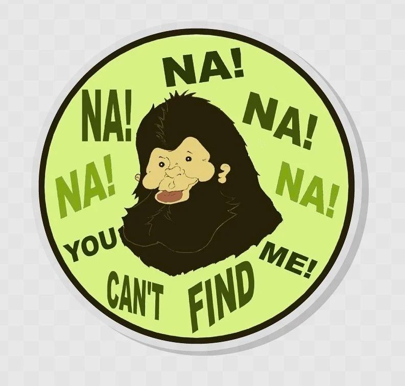 Cartoon ape in a green circle with “NA! NA! YOU CAN’T FIND ME!” text on black background