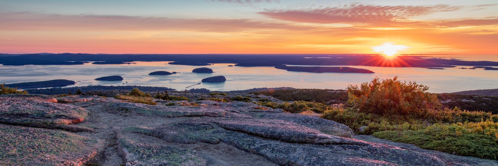 The sun is setting over a large body of water.