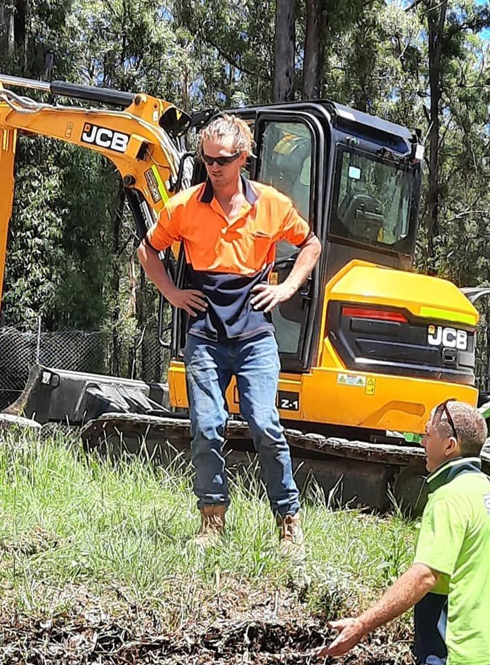 Worker Beside the Excavator — Rainbow Flat, NSW — Tree Solutions NSW