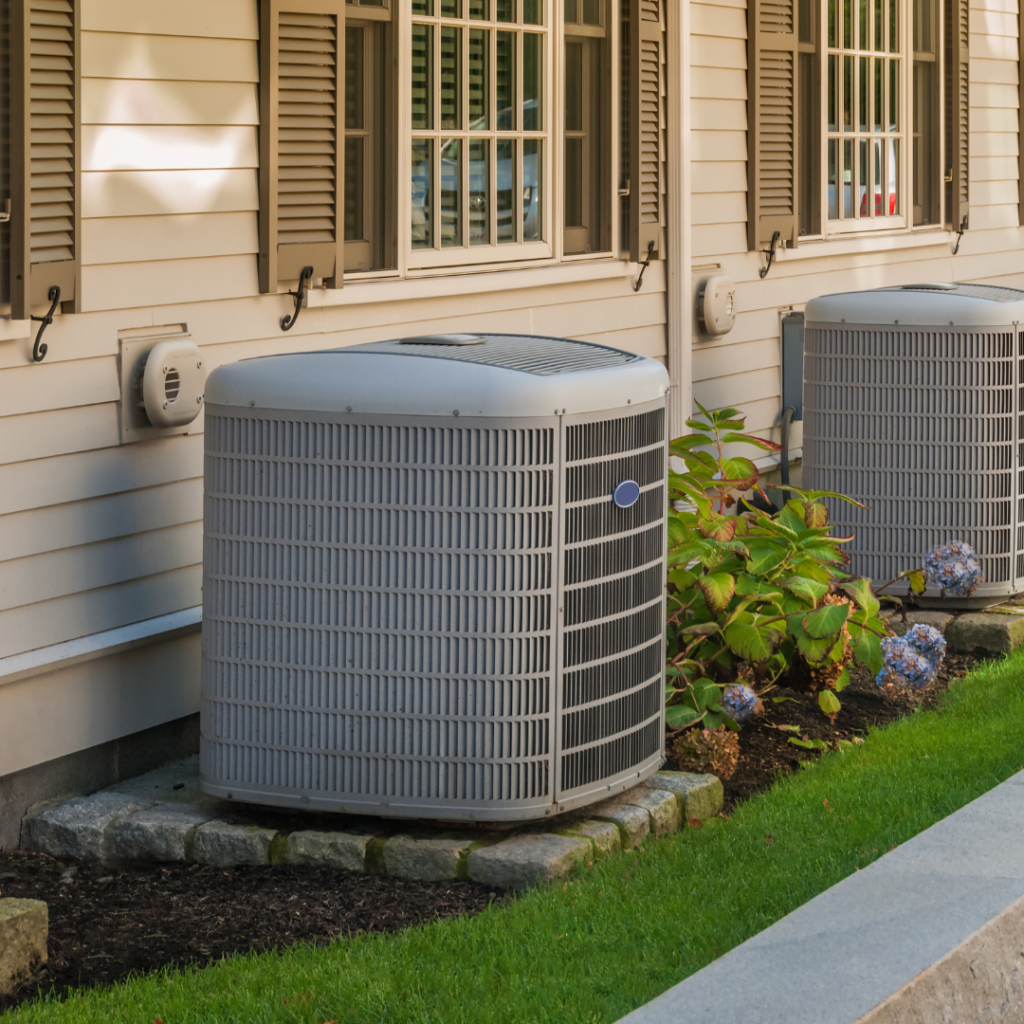 A row of air conditioners outside of a house
