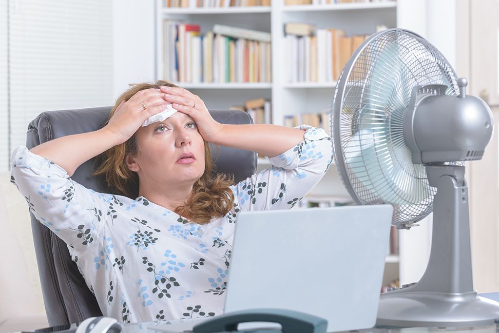 Woman stuck without AC and sweating in office