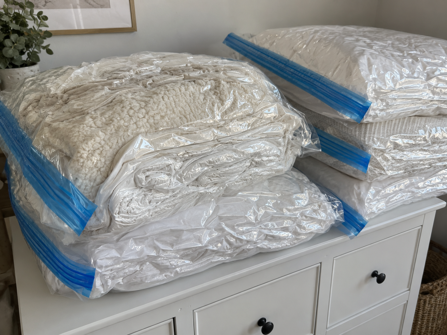 Piles of vacuum sealed bags on a dresser