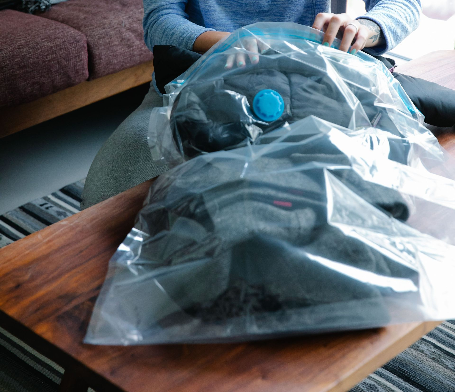 placing clothing in vacuum storage bag