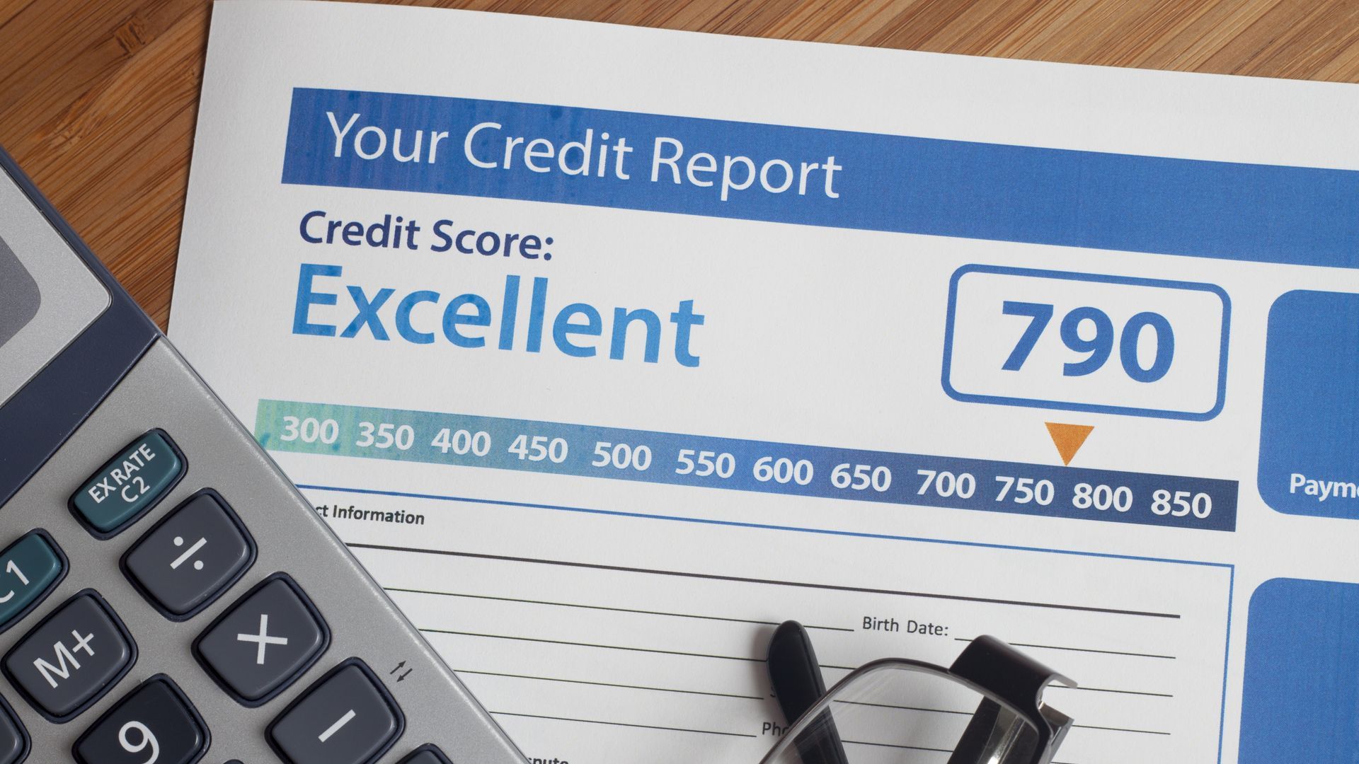 credit report document next to a calculator