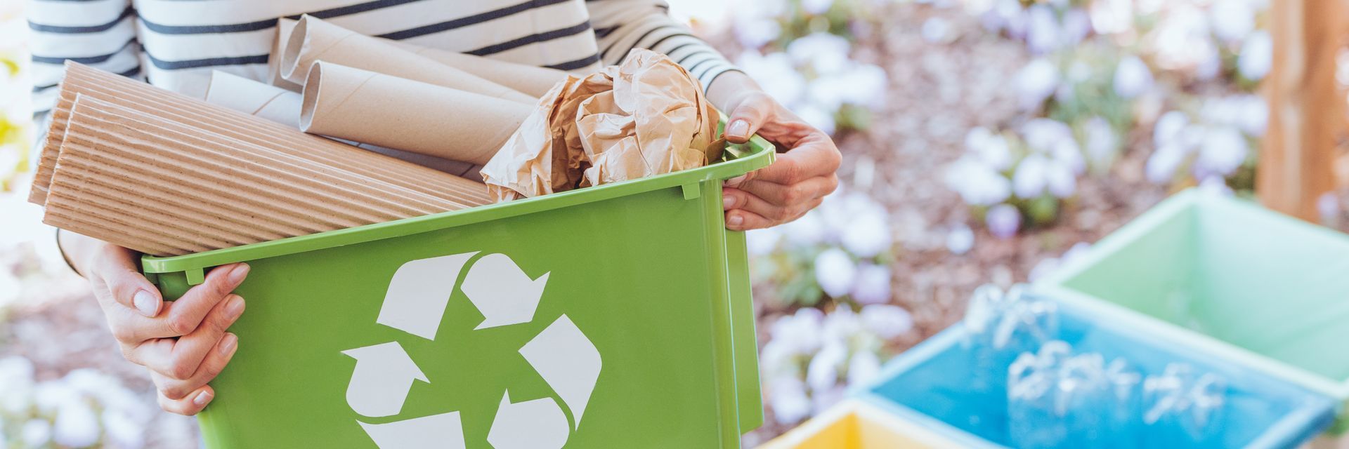 person holding a recycling bin