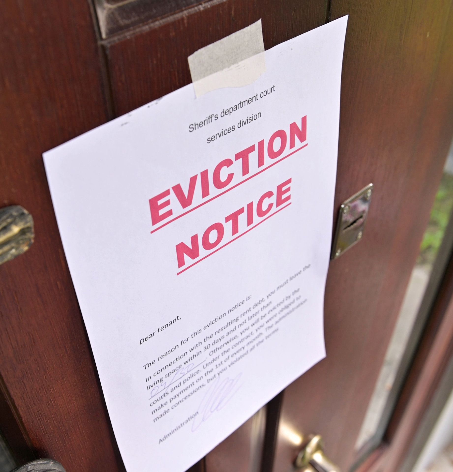 An eviction notice is taped to a door
