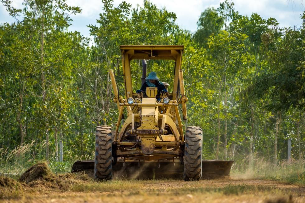 A Yellow Tractor/Truck in Field — SMH Valley Fencing & Maintenance In Millfield, NSW