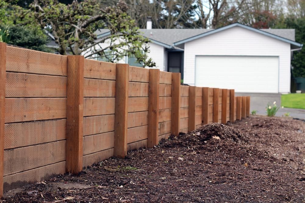 A Wooden Fence in Front of a White House — SMH Valley Fencing & Maintenance In Singleton, NSW