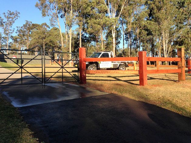 A White Truck is Parked Behind a Red Fence — SMH Valley Fencing & Maintenance In Cessnock, NSW