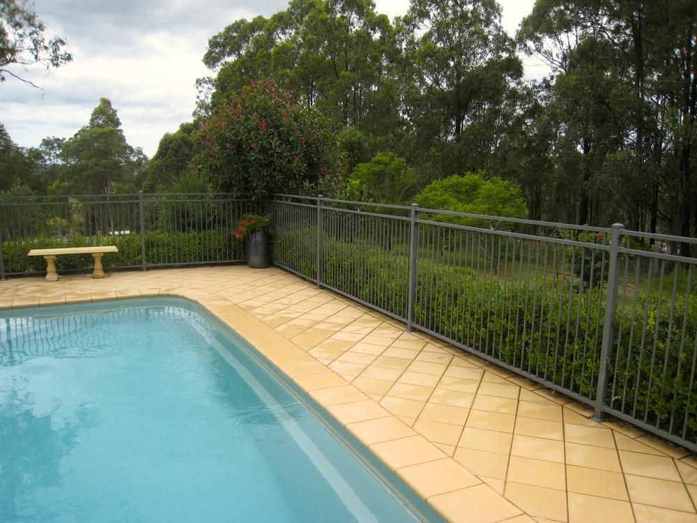 A Metal Fence Surrounds Pool — SMH Valley Fencing & Maintenance In Pokolbin, NSW