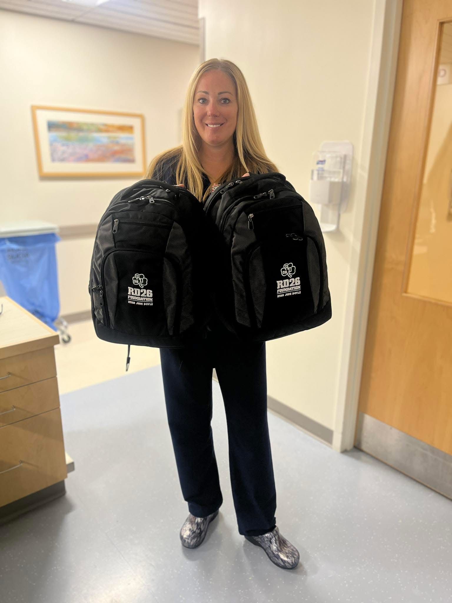 Kelly Laporte O'Brian delivered 25 RD26 Foundation backpacks to pediatric oncology unit.