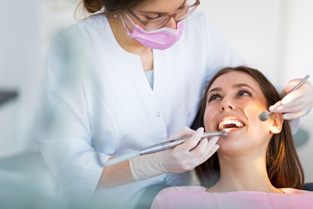 A Woman Is Getting Her Teeth Examined By A Dentist — Regal's Dental In Emu Park, QLD