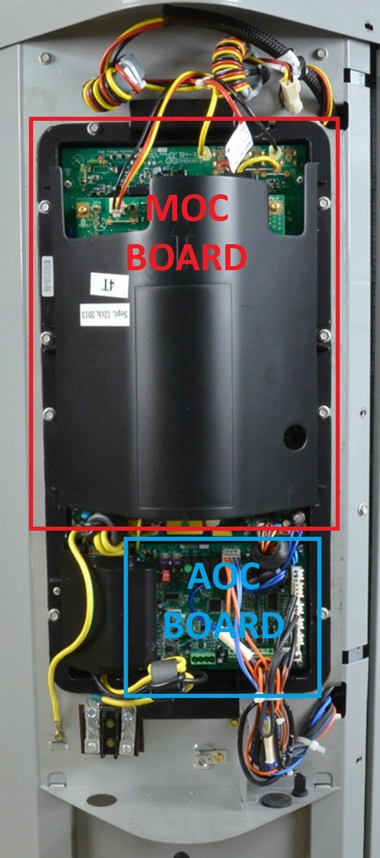 Open electrical cabinet with labeled MOC board and AOC board, wiring visible inside.