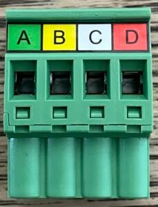 Green 4-slot electrical terminal block labeled A, B, C, and D in colored tabs
