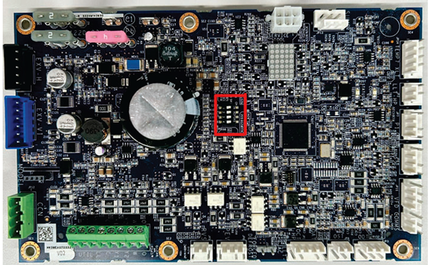 Printed circuit board with a red-outlined component near center, connectors around the edges.