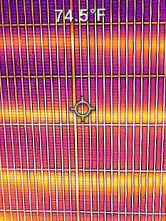 Thermal image of a striped surface with a crosshair centered and temperature reading 74.3°F.