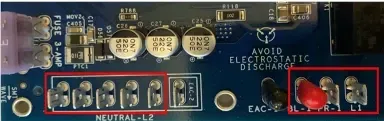 Close-up of a circuit board with labeled components and two red circled connectors on the right.