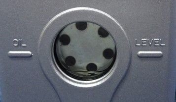 Gray panel with an oil level indicator window and labels “OIL” and “LEVEL” on either side