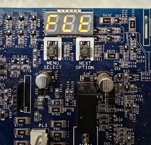 Blue circuit board with 7-segment display and buttons labeled Menu Select and Next Option