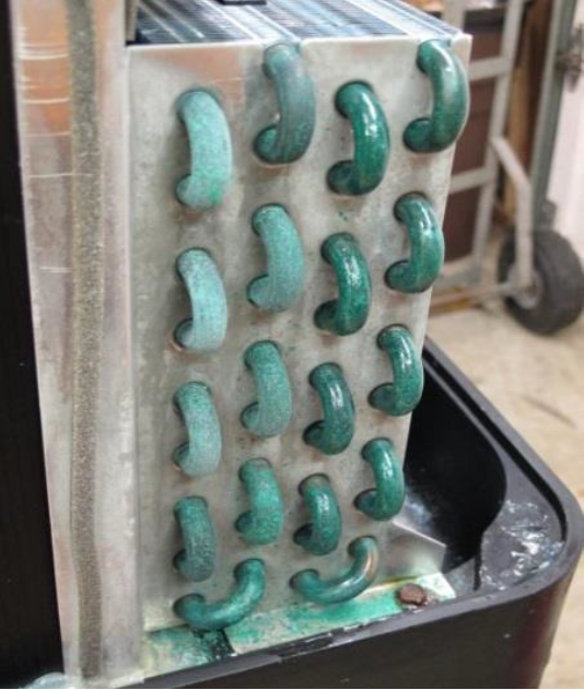 Close-up of a metal plate with rows of green curved handles or hooks attached.