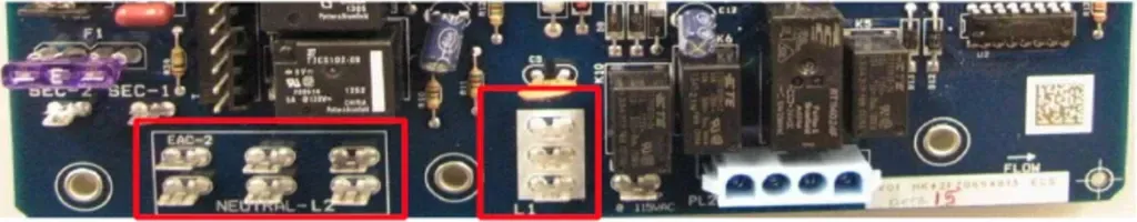 Close-up of a circuit board with two red-outlined component areas highlighted.