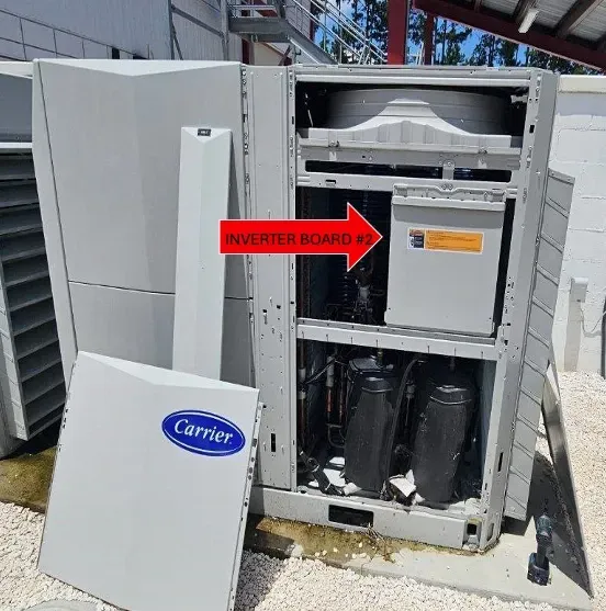 Open HVAC unit with red arrow pointing to inverter board inside, carrier panel open