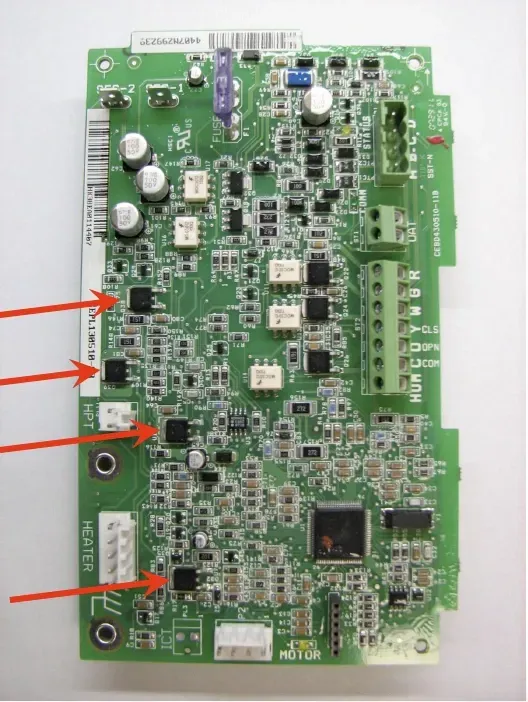 Green circuit board with three red arrows pointing to components on the left side.